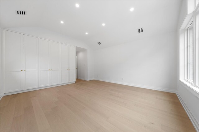 46 Snapdragon Ln, Roslyn Heights, NY 11577 - unfurnished bedroom with vaulted ceiling, light wood-style flooring, recessed lighting, and baseboards