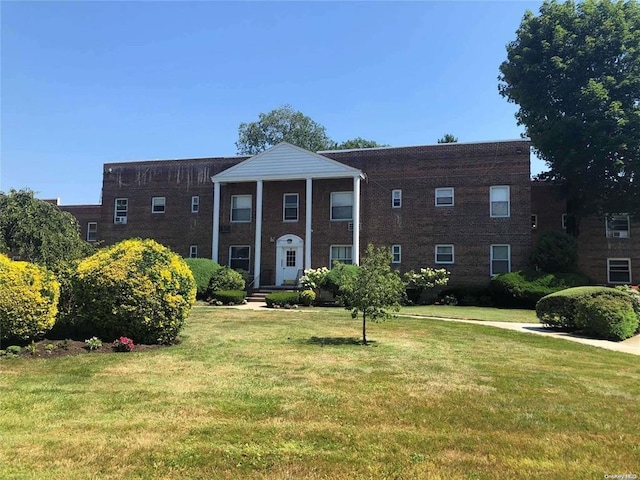 285 Central Ave Unit B4, Lawrence, NY 11559 - greek revival house featuring a front yard and brick siding