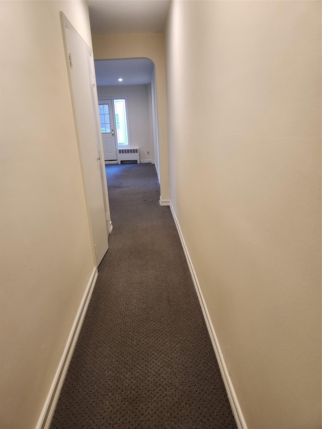 285 Central Ave Unit B4, Lawrence, NY 11559 - corridor featuring dark colored carpet, baseboards, and arched walkways