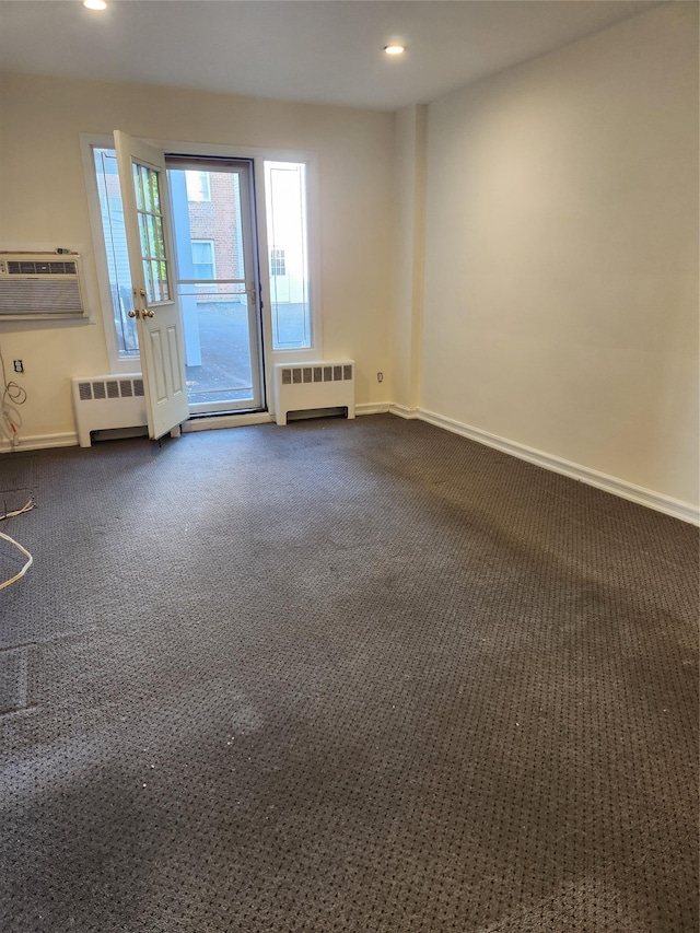 285 Central Ave Unit B4, Lawrence, NY 11559 - empty room with radiator, dark colored carpet, an AC wall unit, baseboards, and recessed lighting