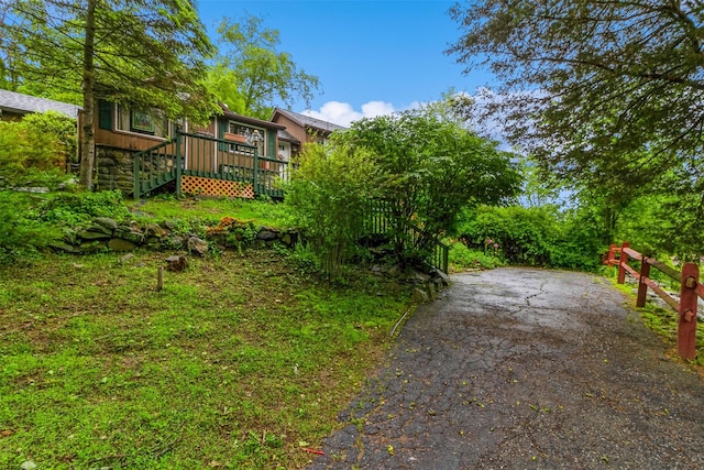 57 Empire Dr, Patterson, NY 12563 - view of yard with a deck, stairs, and asphalt driveway