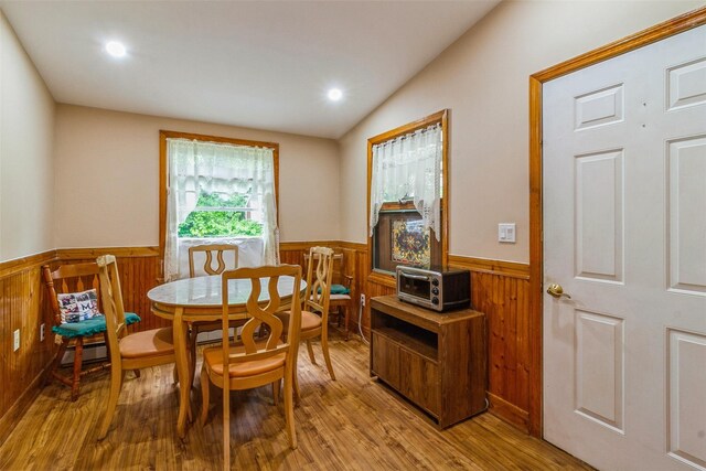 57 Empire Dr, Patterson, NY 12563 - dining area featuring a wainscoted wall, wood finished floors, baseboard heating, wooden walls, and recessed lighting
