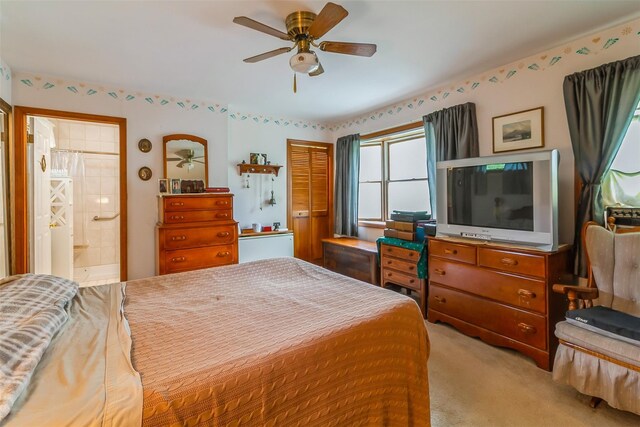 57 Empire Dr, Patterson, NY 12563 - bedroom with light colored carpet, connected bathroom, and ceiling fan