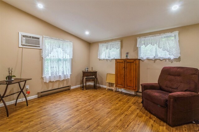 57 Empire Dr, Patterson, NY 12563 - living area with a baseboard radiator, light wood-type flooring, lofted ceiling, recessed lighting, and a wall mounted air conditioner