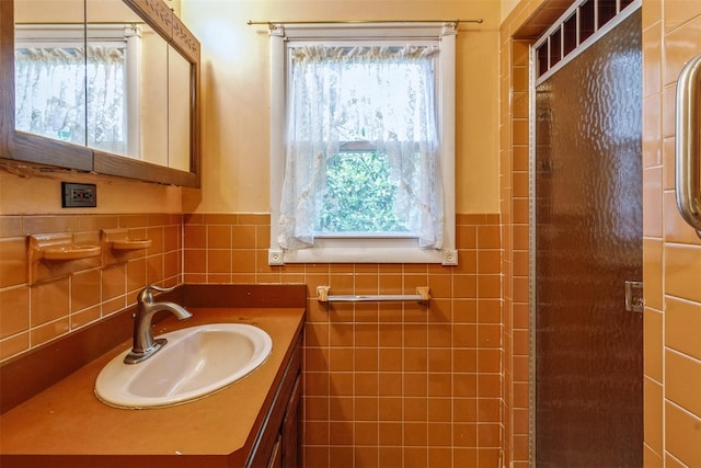 57 Empire Dr, Patterson, NY 12563 - bathroom featuring vanity, tile walls, a stall shower, and a wainscoted wall