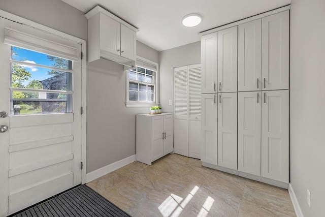laundry room featuring baseboards