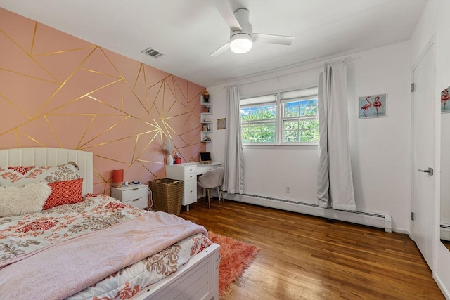 bedroom with baseboard heating, wood finished floors, and a ceiling fan