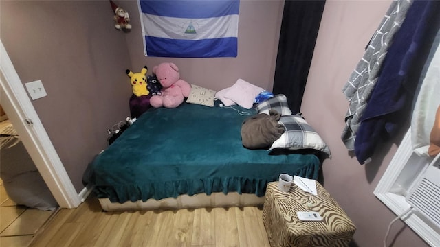 bedroom featuring wood finished floors