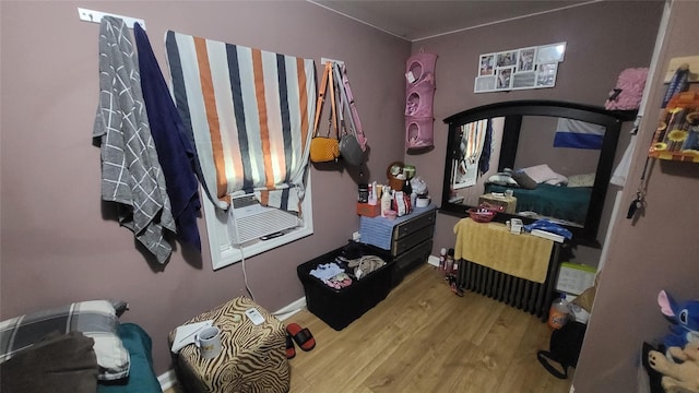 bedroom featuring wood finished floors and baseboards