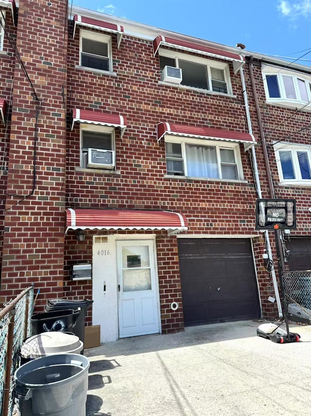 4016 E Tremont Ave, Bronx, NY 10465 - multi unit property featuring an attached garage, brick siding, and driveway