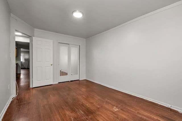4016 E Tremont Ave, Bronx, NY 10465 - unfurnished bedroom with dark wood-style floors, baseboards, a closet, and ornamental molding