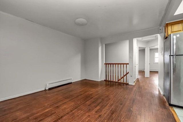 4016 E Tremont Ave, Bronx, NY 10465 - unfurnished room featuring baseboard heating, hardwood / wood-style floors, and baseboards