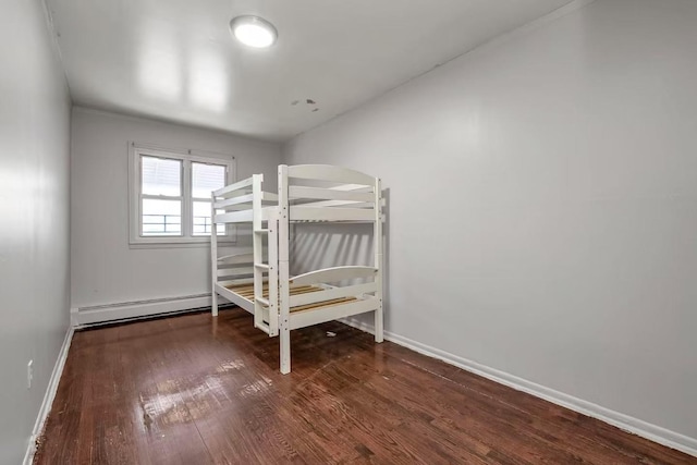 4016 E Tremont Ave, Bronx, NY 10465 - unfurnished bedroom with wood finished floors and baseboards