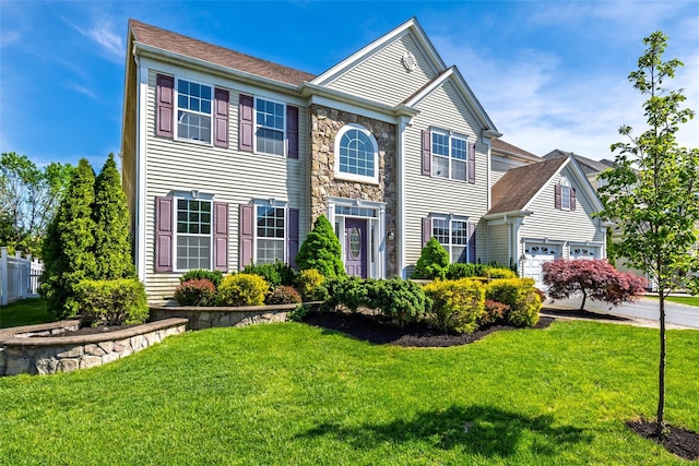 33 Avolet Ct, Mount Sinai, NY 11766 - view of front of house with a front yard, stone siding, driveway, and a garage