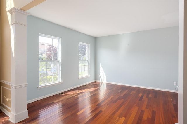 33 Avolet Ct, Mount Sinai, NY 11766 - spare room with dark wood-style flooring, decorative columns, and baseboards