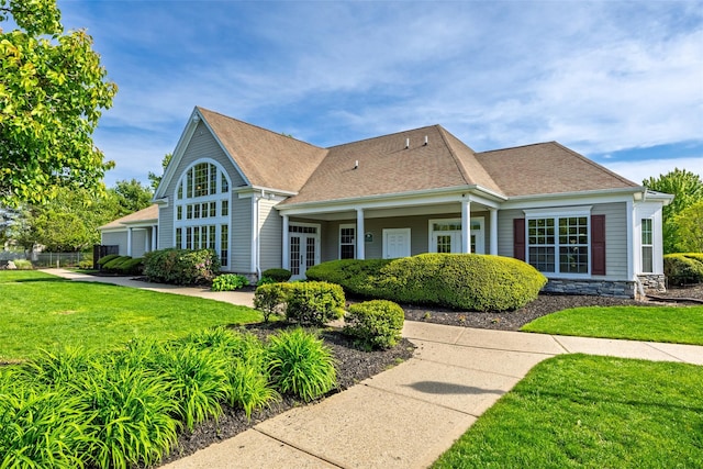 33 Avolet Ct, Mount Sinai, NY 11766 - view of front of home featuring a front yard, roof with shingles, and stone siding