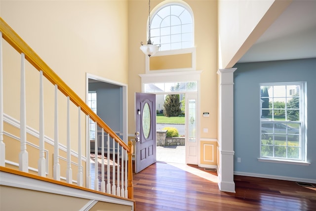 33 Avolet Ct, Mount Sinai, NY 11766 - entryway featuring wood-type flooring, stairs, a high ceiling, ornate columns, and baseboards