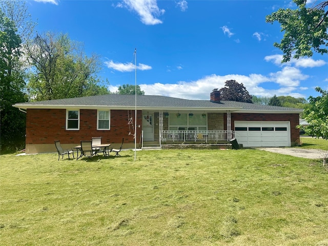 15 Queen St, New Windsor, NY 12553 - view of front of house featuring a garage, covered porch, a front yard, a chimney, and brick siding