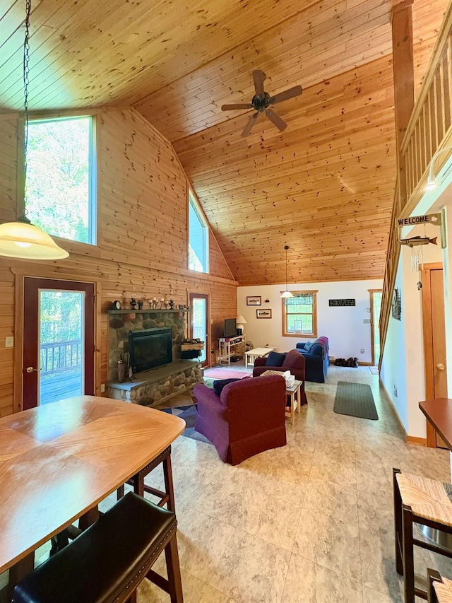 456 Anderson Rd, Parksville, NY 12768 - living room with high vaulted ceiling, a fireplace, stairway, wooden ceiling, and wood walls