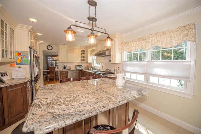 184 Dorothy Rd, West Islip, NY 11795 - kitchen featuring under cabinet range hood, appliances with stainless steel finishes, light stone counters, baseboards, and a kitchen island
