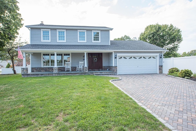 184 Dorothy Rd, West Islip, NY 11795 - view of front facade with an attached garage, decorative driveway, stone siding, a porch, and a chimney