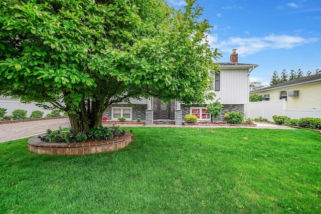 248 44th St, Lindenhurst, NY 11757 - view of front of property with stone siding and a chimney