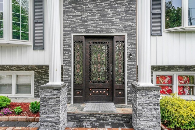 248 44th St, Lindenhurst, NY 11757 - property entrance featuring board and batten siding and stone siding