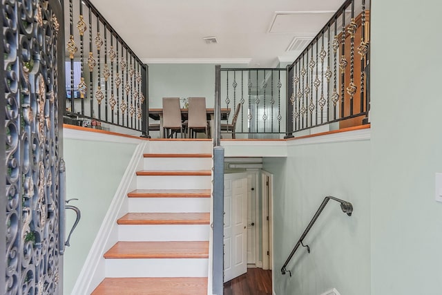 248 44th St, Lindenhurst, NY 11757 - stairs with wood finished floors, attic access, and crown molding