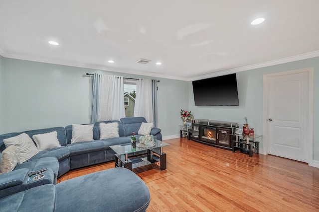 248 44th St, Lindenhurst, NY 11757 - living room featuring crown molding, light wood-style floors, baseboards, and recessed lighting