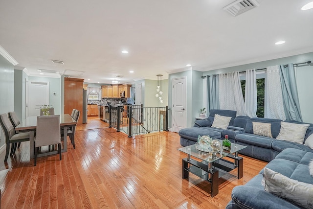 248 44th St, Lindenhurst, NY 11757 - living room featuring ornamental molding, plenty of natural light, light wood-style flooring, recessed lighting, and baseboards
