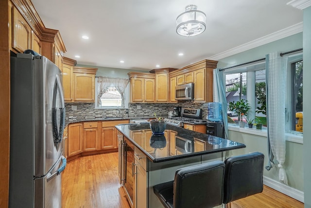 248 44th St, Lindenhurst, NY 11757 - kitchen featuring stainless steel appliances, light wood-style floors, tasteful backsplash, healthy amount of natural light, and crown molding