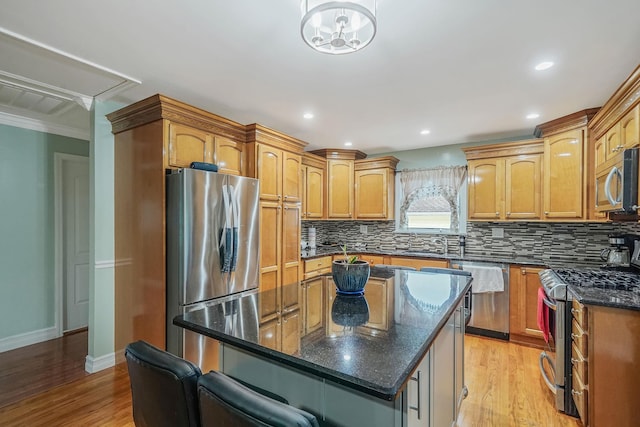 248 44th St, Lindenhurst, NY 11757 - kitchen with stainless steel appliances, a center island, decorative backsplash, light wood-style floors, and ornamental molding