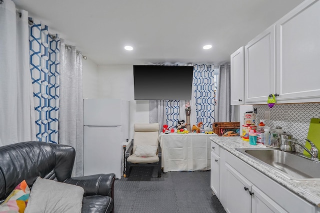 248 44th St, Lindenhurst, NY 11757 - kitchen with freestanding refrigerator, a sink, open floor plan, white cabinetry, and tasteful backsplash