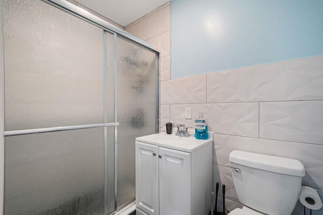 248 44th St, Lindenhurst, NY 11757 - full bathroom with tile walls, a stall shower, toilet, and vanity