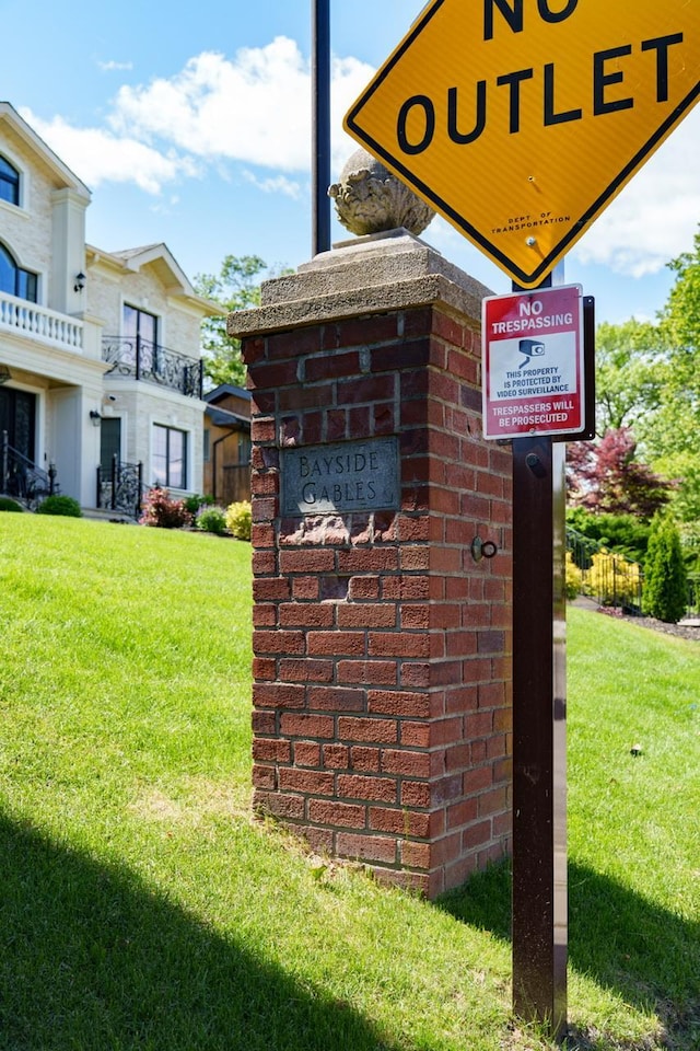 community / neighborhood sign with a lawn