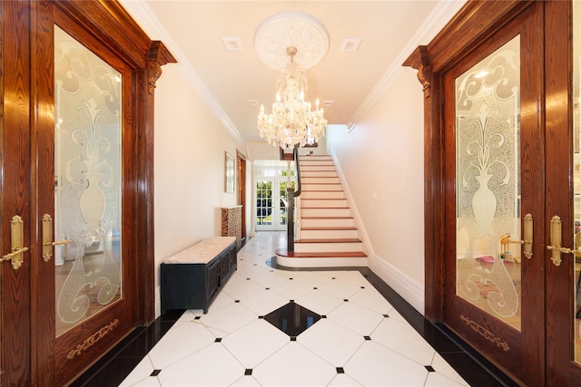 foyer entrance with crown molding, a chandelier, stairs, and baseboards