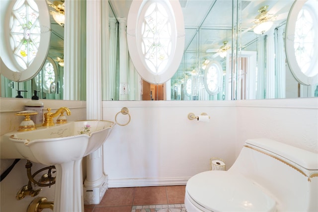 bathroom with tile patterned flooring, plenty of natural light, and toilet