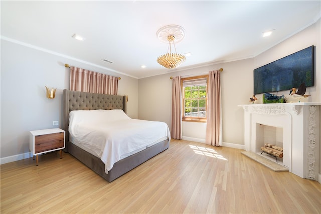 bedroom featuring light wood-style floors, baseboards, and ornamental molding
