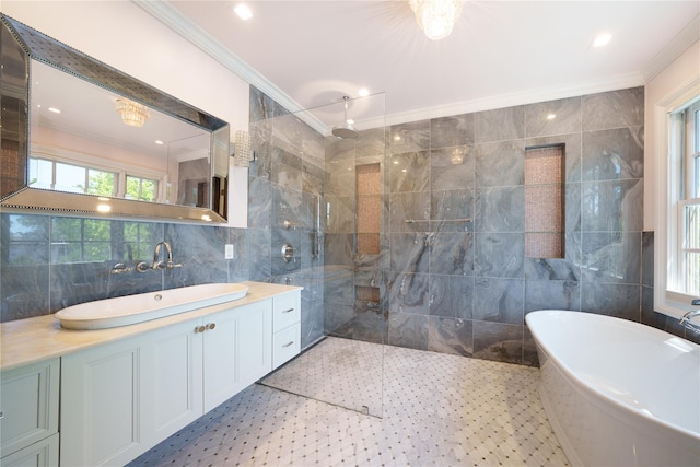 full bath with tile walls, ornamental molding, a freestanding tub, vanity, and walk in shower