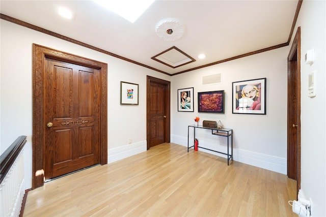 hall with light wood-style flooring, baseboards, recessed lighting, and crown molding