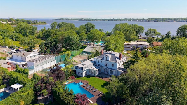 bird's eye view of a pool area and a large body of water