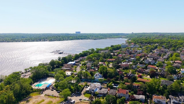 aerial view of residential area featuring a nearby body of water and a pool