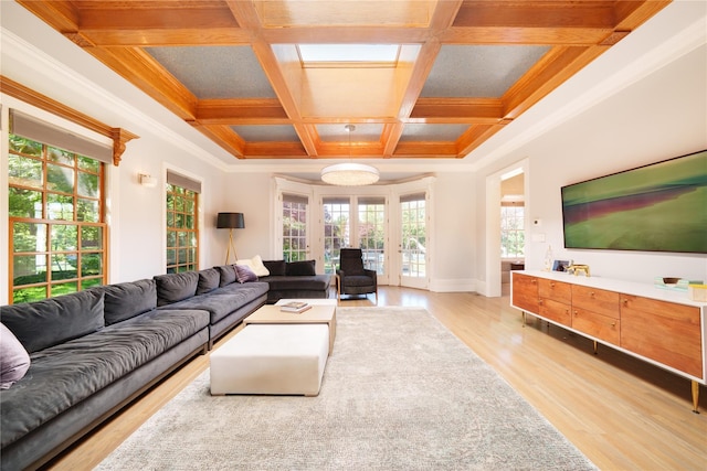 living room with coffered ceiling, light wood-style flooring, baseboards, beam ceiling, and ornamental molding