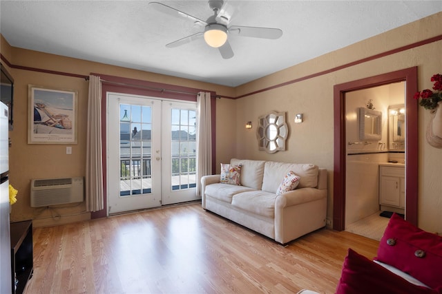 52 Main St Unit 6, Westhampton Beach, NY 11978 - living area featuring a wall unit AC, light wood finished floors, ceiling fan, and french doors
