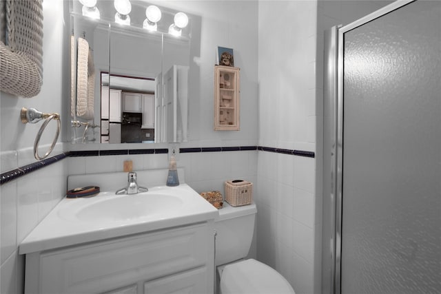 52 Main St Unit 6, Westhampton Beach, NY 11978 - bathroom featuring a shower stall, vanity, toilet, and tile walls