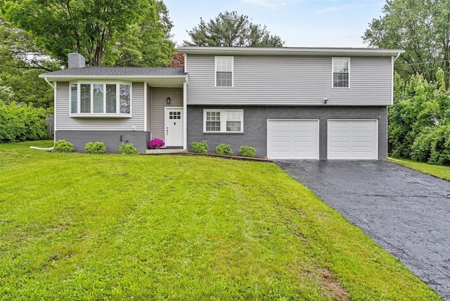 112 Edgehill Dr, Wappingers Falls, NY 12590 - split level home with asphalt driveway, a chimney, an attached garage, a front yard, and brick siding