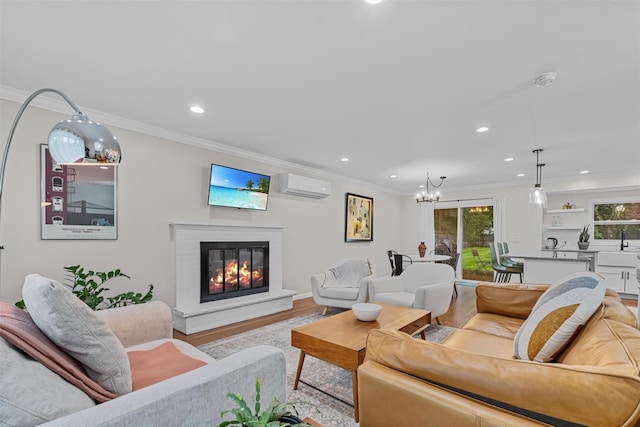 112 Edgehill Dr, Wappingers Falls, NY 12590 - living area featuring recessed lighting, a chandelier, a glass covered fireplace, wood finished floors, and ornamental molding