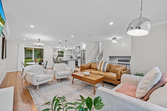 112 Edgehill Dr, Wappingers Falls, NY 12590 - living room featuring ornamental molding, recessed lighting, stairs, light wood-style floors, and a chandelier
