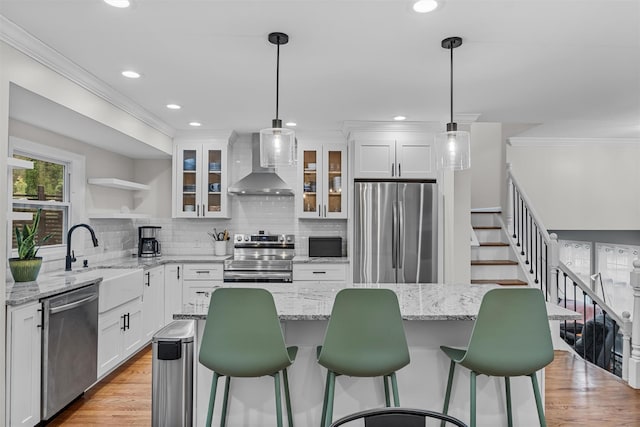 112 Edgehill Dr, Wappingers Falls, NY 12590 - kitchen featuring stainless steel appliances, wall chimney exhaust hood, ornamental molding, open shelves, and white cabinets