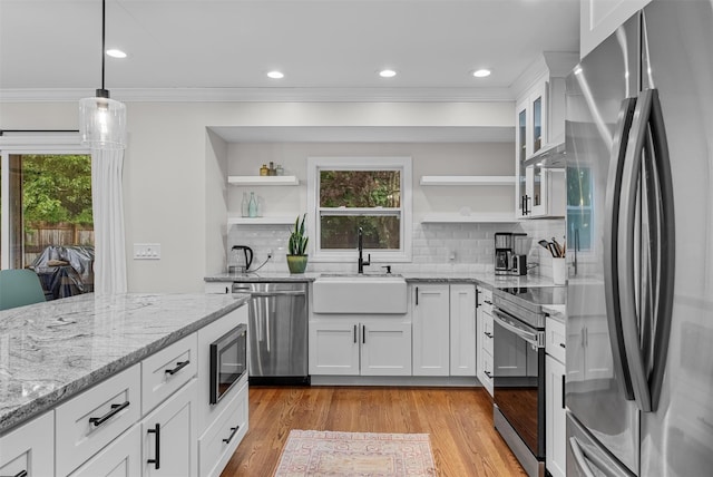 112 Edgehill Dr, Wappingers Falls, NY 12590 - kitchen with stainless steel appliances, open shelves, a sink, crown molding, and white cabinetry